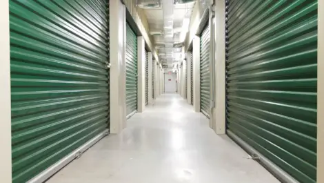 Rows of indoor green storage units at KO Storage of Victoria - Beauvoir St