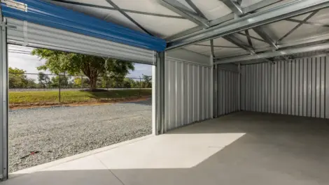 Interior of an empty storage unit with concrete floor and walls.