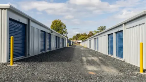 Exterior view of multiple storage units with paved access in front.